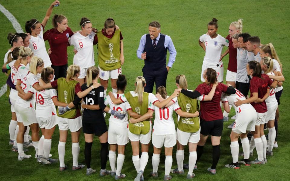 England manager Phil Neville talks to the players in a team huddle after the match - Reuters