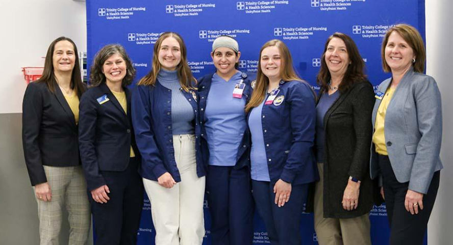 Augie president Andrea Talentino, left, and provost Dianna Shandy, right, pose with members of Augustana’s Admissions Office and 2023 Augustana nursing graduates at the signing event for the direct-entry program on Thursday, March 7, 2024.