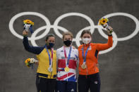 Bethany Shriever of Britain, center, Mariana Pajon of Colombia, left, and Merel Smulders of the Netherlands, right, stand with their medals in the women's BMX Racing finals at the 2020 Summer Olympics, Friday, July 30, 2021, in Tokyo, Japan. (AP Photo/Ben Curtis)