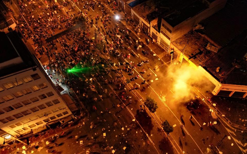 Police try to disperse the demonstrators taking part in a massive protest march against the new government  - Cristian Olea/EPA-EFE/Shutterstock