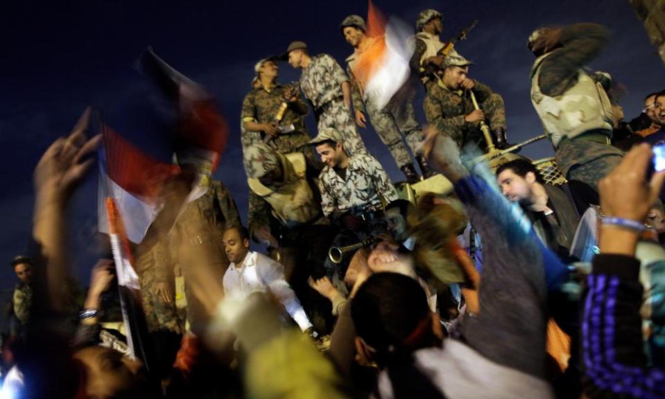 Protesters and soldiers celebrate together in Tahrir Square, Cario, on 11 February 2011 after the announcement of the resignation of Hosni Mubarak.