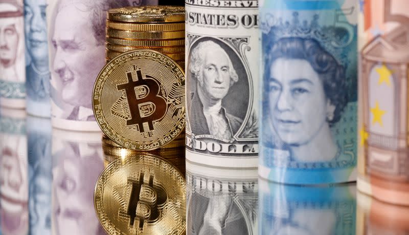 FILE PHOTO: Representations of Bitcoin, Saudi riyal, yuan, Turkish lira, pound, U.S. dollar, ruro and Jordanian dinar banknotes are seen in this illustration