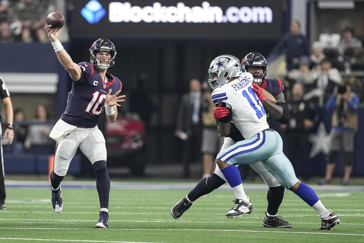 Houston Texans quarterback Davis Mills (10) throws a pass under pressure from Dallas Cowboys linebacker Micah Parsons (11) on Dec. 11, 2022, in Arlington, Texas. (AP Photo/Tony Gutierrez)