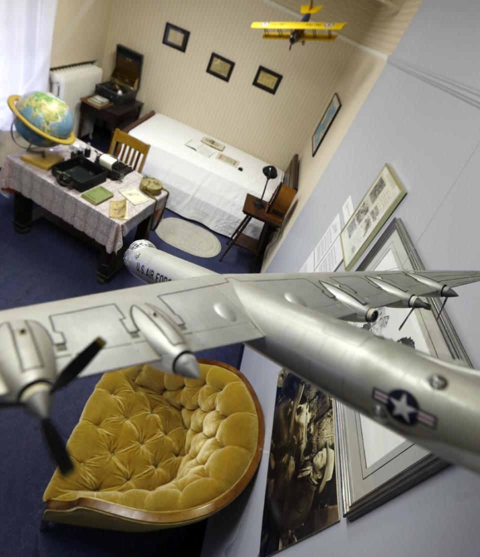 In this photo made on Friday, Dec. 20, 2013, a pair of model airplanes hang from the ceiling of a room at the Jimmy Stewart Museum in Indiana, Pa. Local students came up with a scheme that reflected what a teenage Jimmy Stewart's bedroom would look have looked like. The museum dedicated to the life of the star of many films is located in the off-the-beaten track town where Stewart grew up. The museum still attracts visitors from all over the country. It’s full of displays not just about Hollywood, but about Stewart’s service as a bomber pilot in World War II, his well-to-do ancestors, and his family life. (AP Photo/Keith Srakocic)