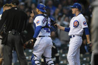 Chicago Cubs catcher Willson Contreras (40) is held back by starting pitcher Keegan Thompson right, after Pittsburgh Pirates' Daniel Vogelbach (19) and Contreras collided at home plate during the fourth inning of a baseball game Tuesday, May 17, 2022, in Chicago. (AP Photo/Paul Beaty)