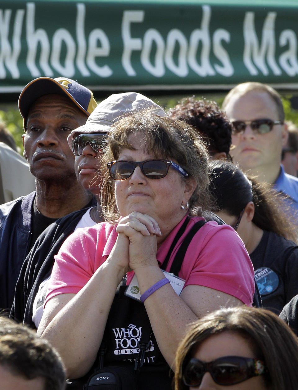 Whole Foods Market employee Lisa Pambid watches during a ground breaking ceremony for the retailer in Detroit, Monday, May 14, 2012. The Austin, Texas-based retailer plans to open a 20,000-square-foot supermarket with about 75 employees next year. The company began looking at Midtown in 2010. (AP Photo/Carlos Osorio)