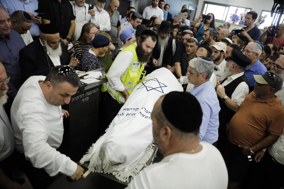 People attend the fineral of 17 year opld Rina Shnerb, in Lod, Israel, Friday, Aug. 23, 2019. Shnerb has died of wounds from an explosion in the West Bank that the Israeli military has described as a Palestinian attack. (AP Photo/Sebastian Scheiner)