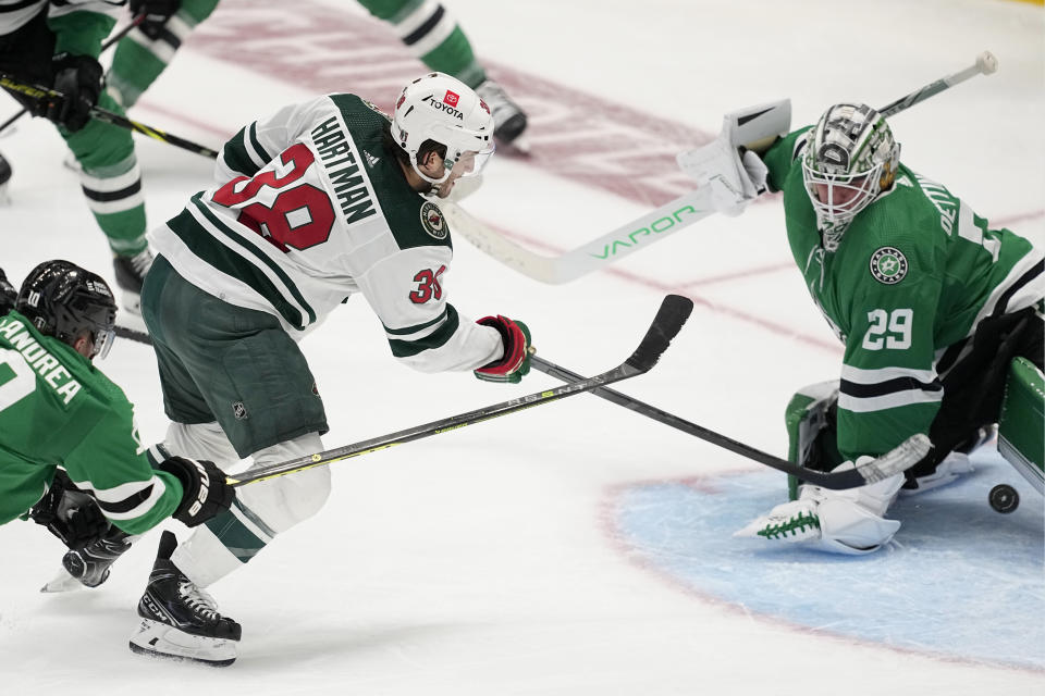 Minnesota Wild right wing Ryan Hartman (38) shoots and scores against Dallas Stars goaltender Jake Oettinger (29) in the second overtime of Game 1 of an NHL hockey Stanley Cup first-round playoff series, Tuesday, April 18, 2023, in Dallas. The Wild won 3-2. (AP Photo/Tony Gutierrez)