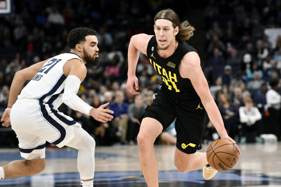 Utah Jazz forward Kelly Olynyk drives against Memphis Grizzlies guard Tyus Jones (21) in the first half of an NBA basketball game, Sunday, Jan. 8, 2023, in Memphis, Tenn. (AP Photo/Brandon Dill)