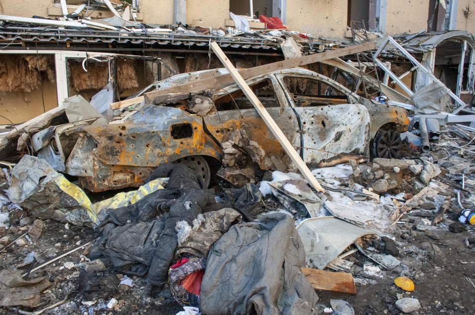 A car destroyed by shelling is seen in a street in Kharkiv, Ukraine, Tuesday, March 22, 2022. (AP Photo/Andrew Marienko)