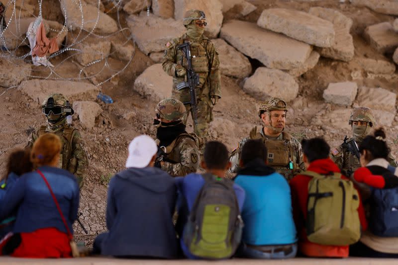 Migrants are seen near the Rio Bravo river after crossing the border to request asylum in the United States, as seen from Ciudad Juarez