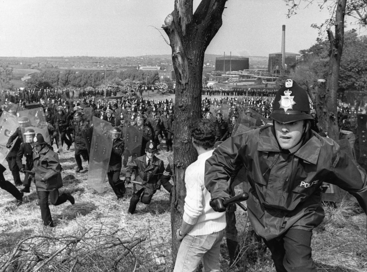Miners Strike 1984. Battle of Orgreave 18th June 1984 Thousands of striking miners picket outside the Orgreave coke works near Rotherham. Where they were met by huge lines of police who were brought in from all around the country. The miners wanted to stop lorry's loaded with coke from leaving the plant for the steelworks. They thought that would help them win their strike, and help protect their pits, their jobs and their communities. The police were determined to hold them back. The Battle of Orgrave was the turning point in the year long miners strike of 1984. It was the moment the police and governments strategy switched from the defensive, protecting collieries, coking plants and working miners, to the offensive, actively breaking up crowds of pickets and making large numbers of arrests of strikers. Our Picture Shows: Police charging pickets outside the Orgreave Coking Plant. 18th June 1984. (Photo by John VarCharlie Ley/Mirrorpix/Getty Images)