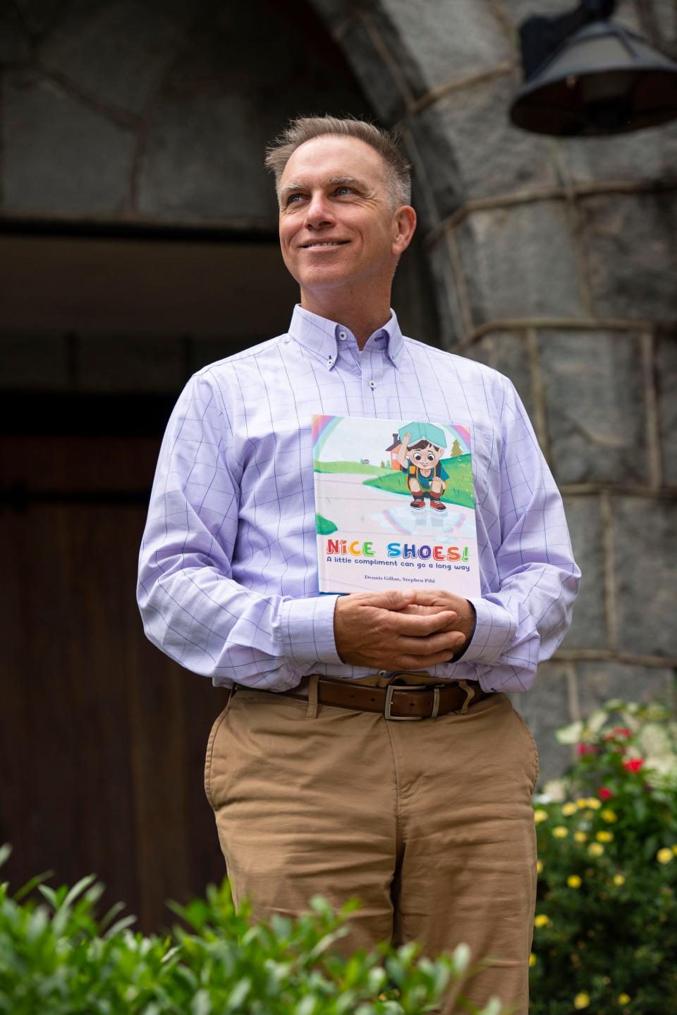 Dennis Gillan poses for a portrait in front of his office building with the book "Nice Shoes!" that he coauthored with Stephen Pihl in Greenville on Thursday, August 18.