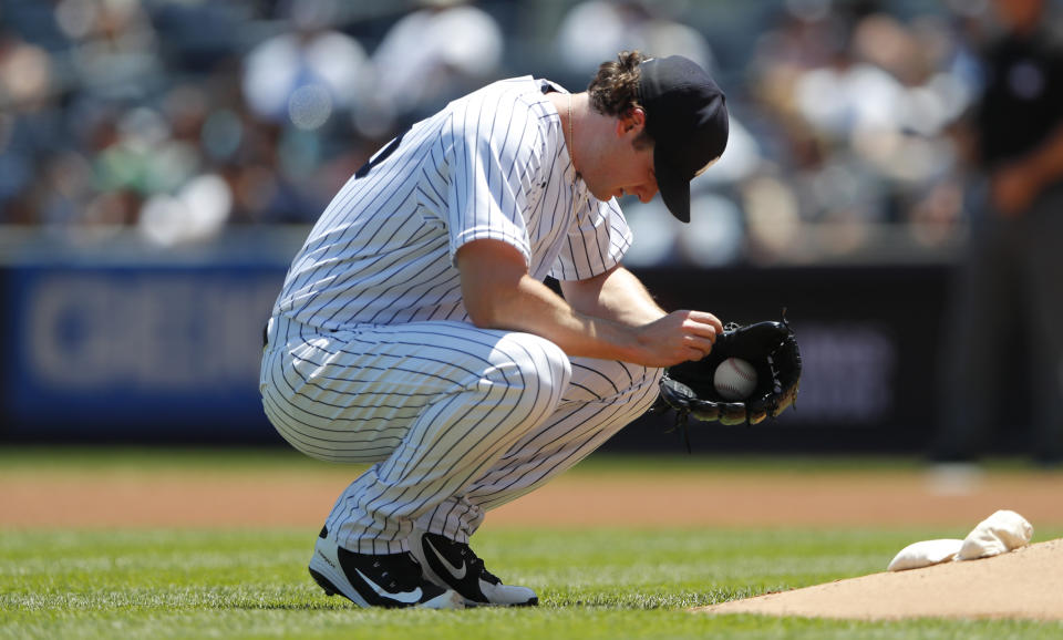 New York Yankees starting pitcher Gerrit Cole (45) pauses before pitching against the Houston Astros during the first inning of a baseball game Saturday, June 25, 2022, in New York. (AP Photo/Noah K. Murray)