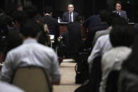 Koichiro Miyahara, center, President and CEO of Tokyo Stock Exchange, Inc. (TSE), and other officers attend a press conference at the Tokyo Stock Exchange Thursday, Oct. 1, 2020, in Tokyo. Trading on the Tokyo Stock Exchange was suspended Thursday because of a problem in the system for relaying market information. Most other Asian markets were closed for national holidays. (AP Photo/Eugene Hoshiko)