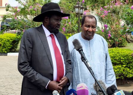 South Sudan's President Salva Kiir, flanked by Mali's former President Alpha Oumar Konare, African Union High Representative for South Sudan, addresses a news conference at the Presidential State House following the recent fighting in South Sudan's capital Juba, July 14, 2016. REUTERS/Stringer