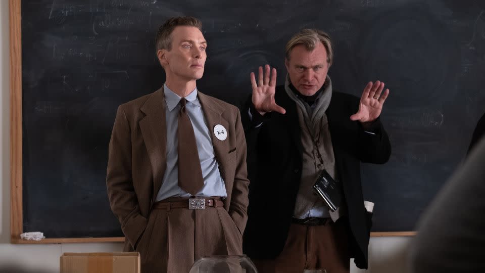 Cillian Murphy (as J. Robert Oppenheimer) and writer, director, and producer Christopher Nolan on the set of "Oppenheimer." - Melinda Sue Gordon/Universal Pictures