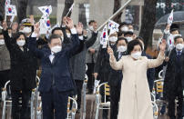 South Korean President Moon Jae-in, front left, and his wife Kim Jung-sook, front right, give three cheers during a ceremony to mark the March First Independence Movement Day, the anniversary of the 1919 uprising against Japanese colonial rule in Seoul, South Korea, Monday, March 1, 2021. (Jewon Heon-kyun/Pool Photo via AP)