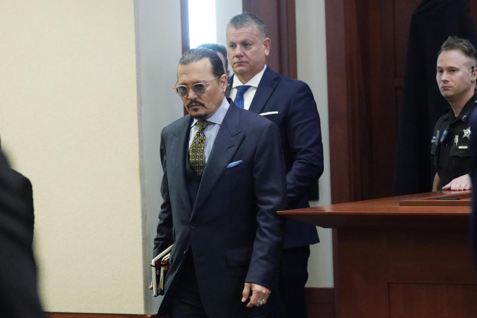 Actor Johnny Depp walks into the courtroom after a break at the Fairfax County Circuit Courthouse in Fairfax, Va., Monday, May 23, 2022. Depp sued his ex-wife Amber Heard for libel in Fairfax County Circuit Court after she wrote an op-ed piece in The Washington Post in 2018 referring to herself as a "public figure representing domestic abuse." (AP Photo/Steve Helber, Pool)