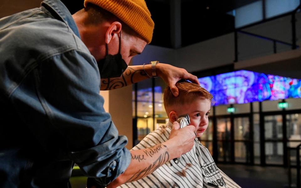 A hairdresser at work at the Van Gogh museum as part of a protest against lockdown restrictions - REUTERS/Piroschka van de Wouw