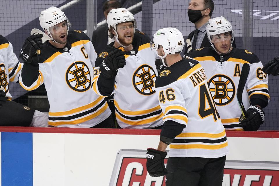 Boston Bruins' David Krejci (46) returns to the bench after scoring during the second period of an NHL hockey game against the Pittsburgh Penguins in Pittsburgh, Tuesday, April 27, 2021.(AP Photo/Gene J. Puskar)