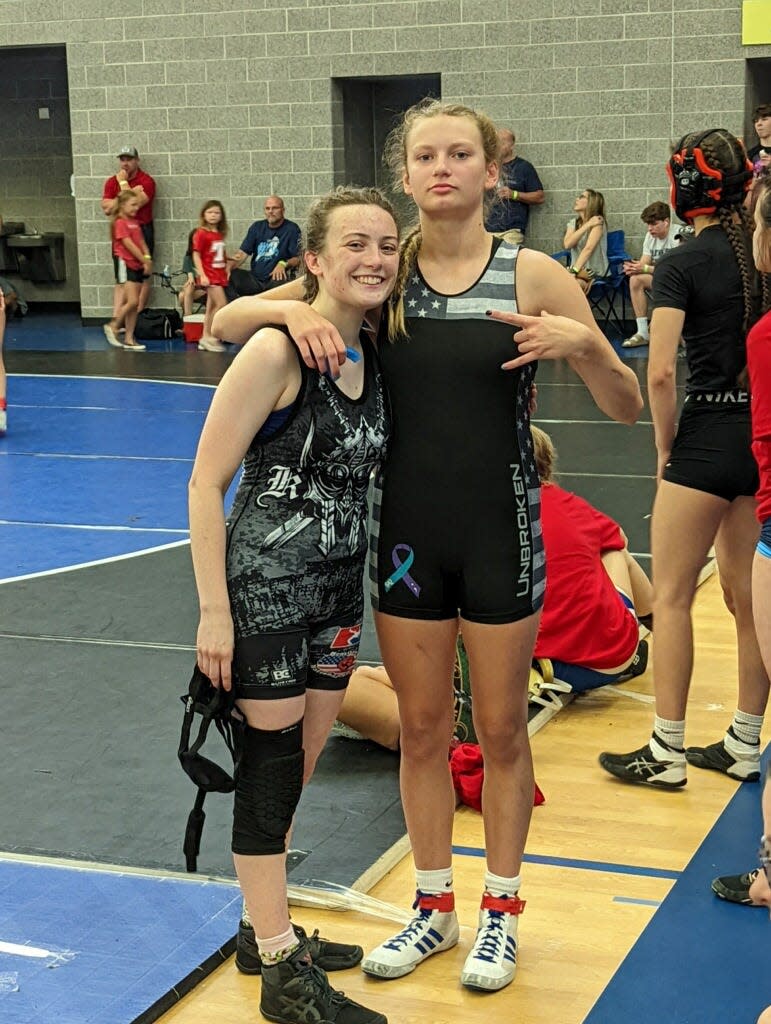 Maddy Arnold, right, was one of three members of the girls wrestling team to approach assistant coach Carl Springer about forming their own team earlier this year.