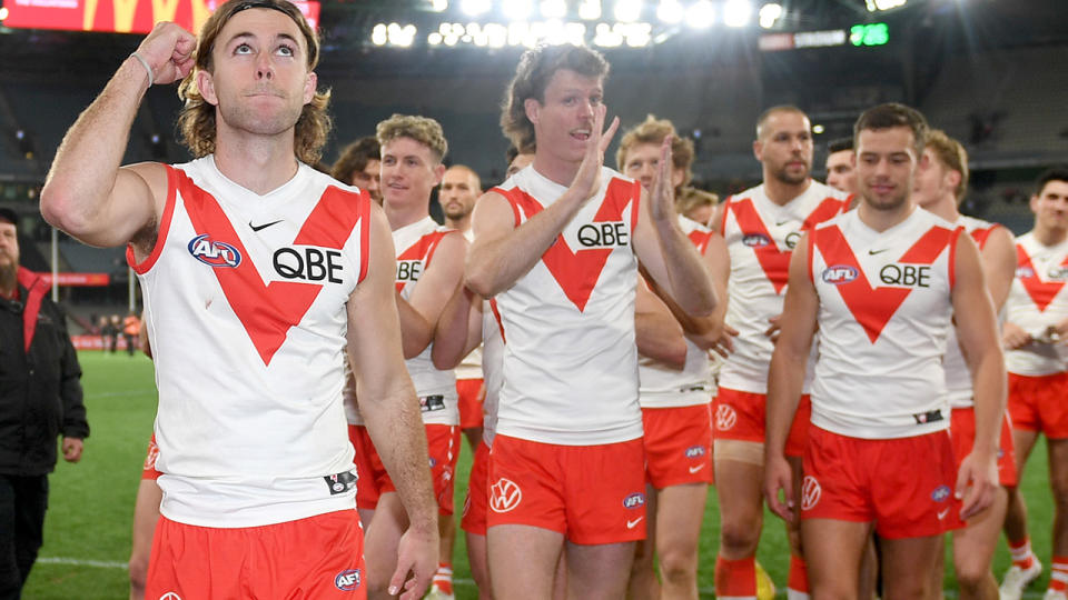 The Sydney Swans celebrate as they walk off the ground after their rund 23 win over St Kilda.