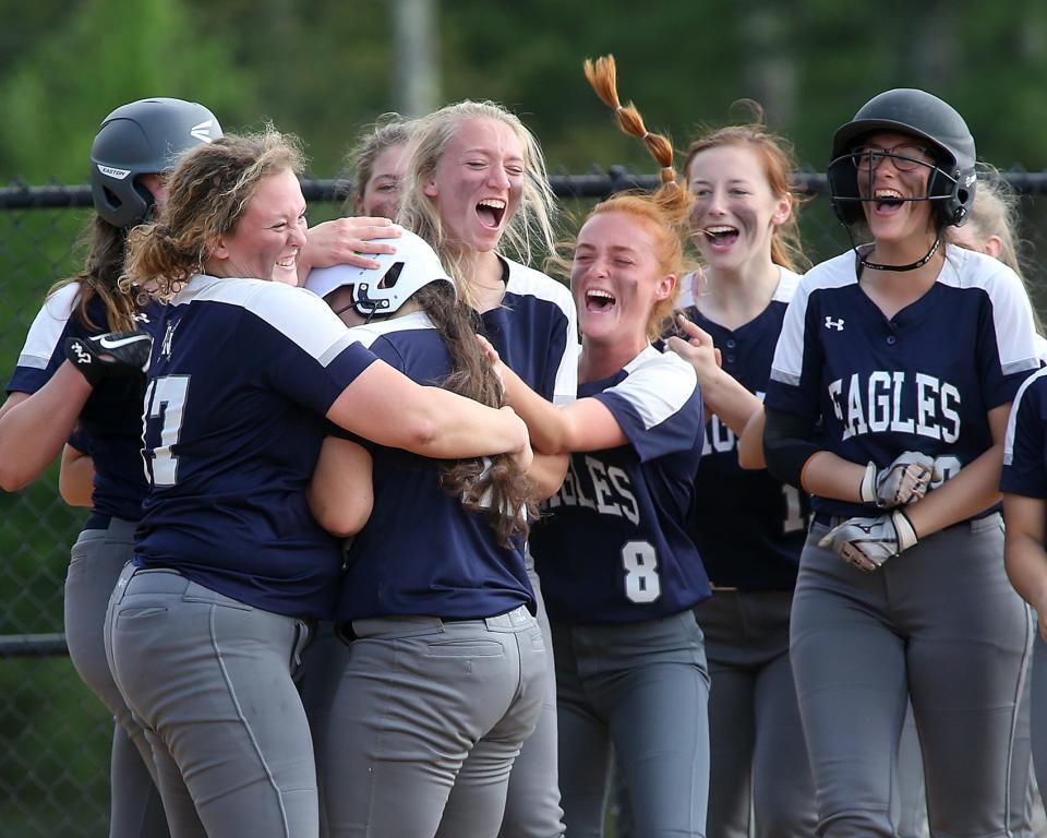 Plymouth North's Maggie Ladd (No. 17), Megan Banzi and Emily Jenkins (No. 8) welcome Plymouth North's Marissa Durette after her home run gave Plymouth North the 4-1 lead over Silver Lake in the top of the third inning of their game at Silver Lake Regional High School on Friday, May 20, 2022.