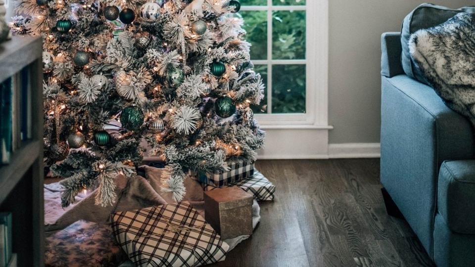 a christmas tree with dark green and black and white ornaments