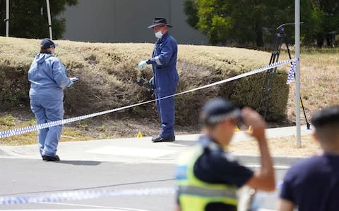 Police investigators at the scene where the body was found in Melbourne - Credit: AAP/&nbsp;Stefan Postles