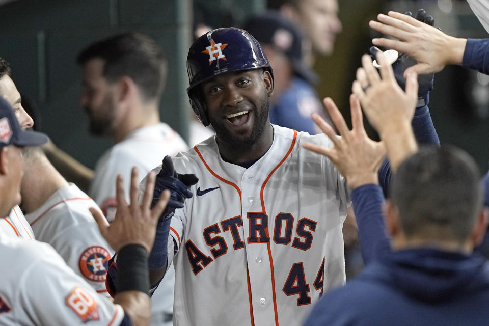 Houston Astros' Yordan Alvarez (44) celebrates with teammates in the dugout after hitting a home run against the New York Mets during the third inning of a baseball game Wednesday, June 22, 2022, in Houston. (AP Photo/David J. Phillip)