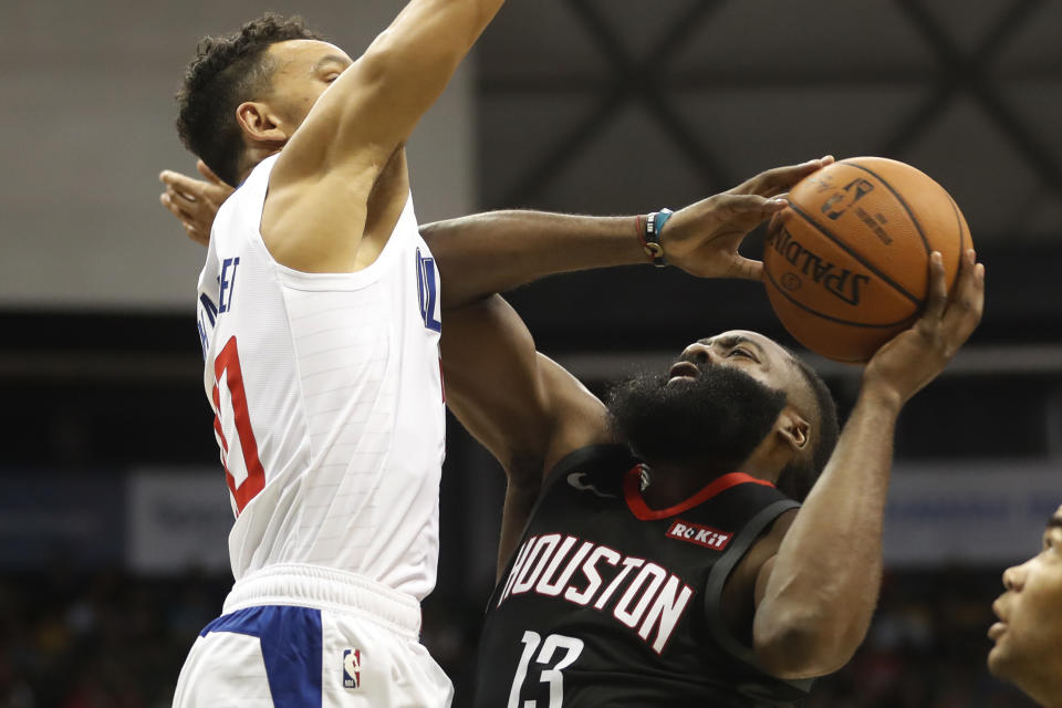 Houston Rockets shooting guard James Harden (13) shoots over Los Angeles Clippers point guard Landry Shamet (20) during the first quarter of an NBA preseason basketball game, Thursday, Oct 3, 2019, in Honolulu. (AP Photo/Marco Garcia)