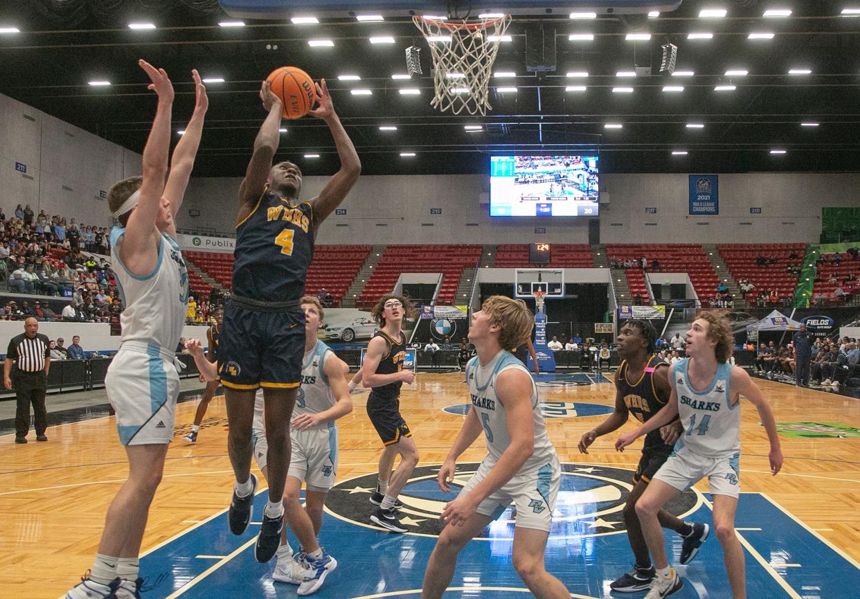 Winter Haven High School's Isaac Celiscar (4) goes up for a basket against Ponte Vedra during the first half of their FHSAA Class 6A state semifinal game at the RP Funding Center in Lakeland.