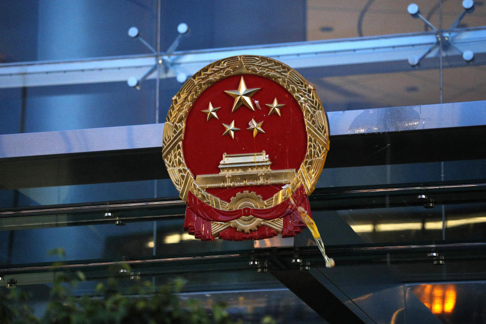 An egg thrown by a protester hits the National Emblem of the People's Republic of China at the Chinese Liaison Office in Hong Kong on Sunday, July 21, 2019. Protesters in Hong Kong pressed on Sunday past the designated end point for a march in which tens of thousands repeated demands for direct elections in the Chinese territory and an independent investigation into police tactics used in previous demonstrations. (AP Photo/Bobby Yip)