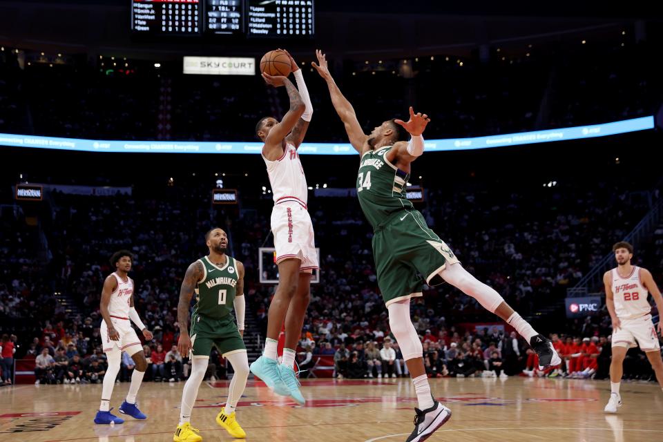 Jabari Smith Jr. of the Rockets shoots the ball over Giannis Antetokounmpo of the Milwaukee Bucks in the first half Saturday night in Houston.