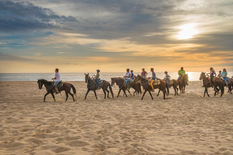 Summertime in Punta Lobos Beach, local people riding horses, Todos Santos, Baja California Sur, Mexico