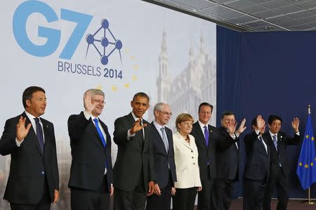 (L-R) Italy's Prime Minister Matteo Renzi, Canada's Prime Minister Stephen Harper, U.S. President Barack Obama, European Council President Herman Van Rompuy, Germany's Chancellor Angela Merkel, Britain's Prime Minister David Cameron, European Commission President Jose Manuel Barroso, France's President Francois Hollande and Japan's Prime Minister Shinzo Abe pose for a group photo during a G7 leaders meeting at European Council headquarters in Brussels June 5, 2014. REUTERS/Yves Herman