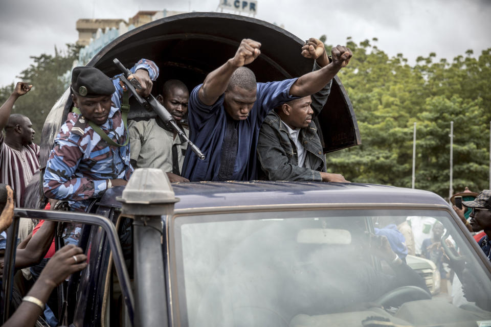 Security forces and others in celebration drive through the streets of the capital Bamako, Mali, Wednesday, Aug. 19, 2020, a day after armed soldiers fired into the air outside President Ibrahim Boubacar Keita's home and took him into their custody. African and Western leaders condemned on Wednesday the junta that forced Mali's president from power, warning the coup was a deep setback for the West African nation that could threaten the battle against Islamic extremism. (AP Photo)