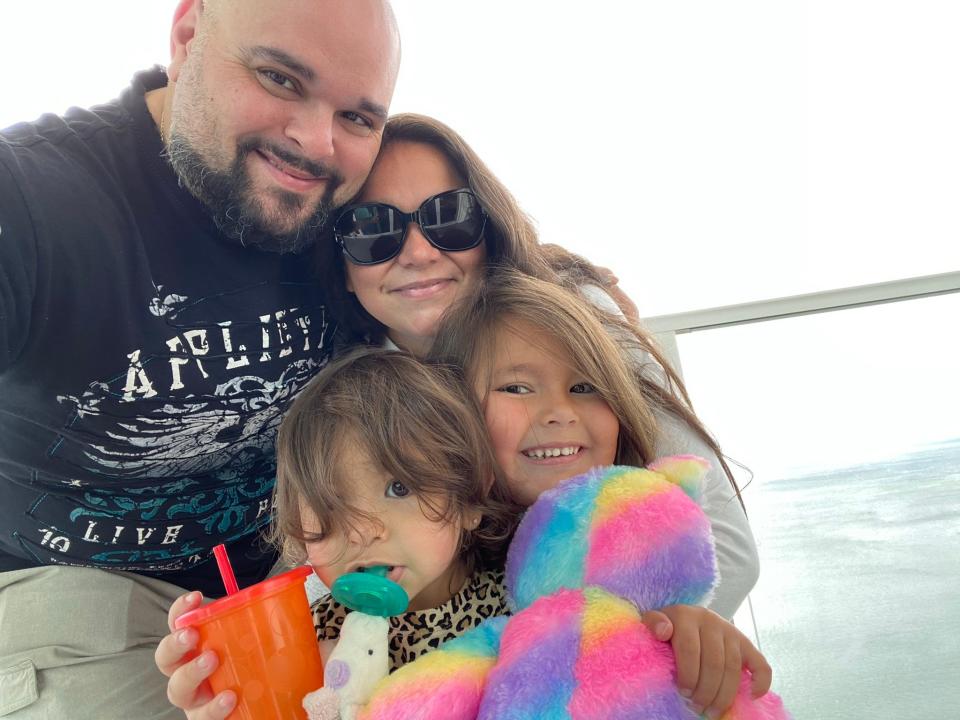 John and Stephanie Livigni with their daughters Milania and Kensington. John is regional director of operations for Regal Cinemas; Stephanie is the new executive director of Bridge Refugee Services.