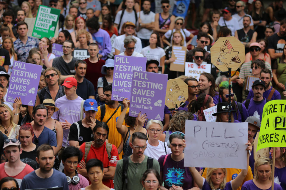 Protesters holding signs in support of pill testing are seen during the Reclaim The Streets Rally in central Sydney, Saturday, January 19, 2019. Source: AAP/Steven Saphore