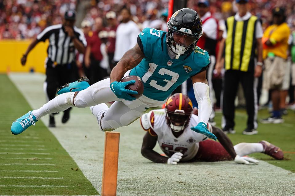 Sep 11, 2022; Landover, Maryland, USA; Jacksonville Jaguars wide receiver Christian Kirk (13) dives for the end zone in front of Washington Commanders linebacker Jamin Davis (52) during the second half at FedExField. Kris was ruled out of bounds on the play. Mandatory Credit: Scott Taetsch-USA TODAY Sports