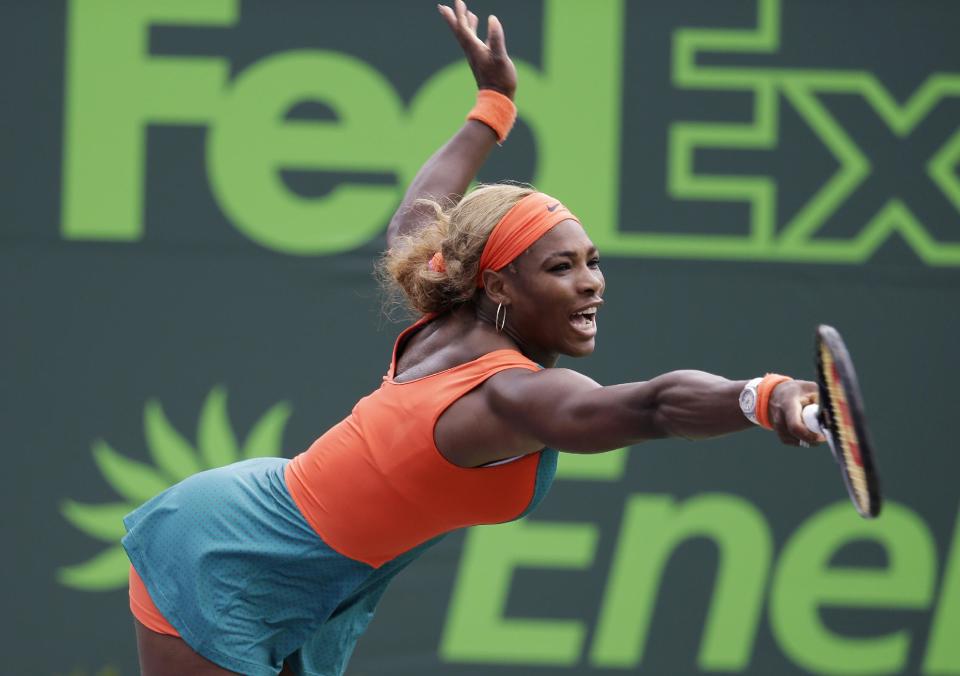 Serena Williams reaches for a serve by Coco Vandeweghe at the Sony Open tennis tournament, Monday, March 24, 2014, in Key Biscayne, Fla. (AP Photo/Lynne Sladky)