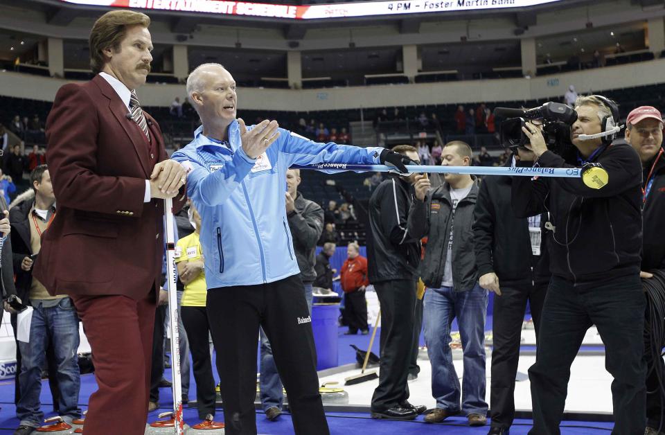 Actor Will Ferrell (L) as Ron Burgundy receives instructions from Skip Glenn Howard prior to the start of the Roar of the Rings Canadian Olympic Curling Trials in Winnipeg, Manitoba December 1, 2013. REUTERS/Trevor Hagan (CANADA - Tags: SPORT ENTERTAINMENT CURLING)