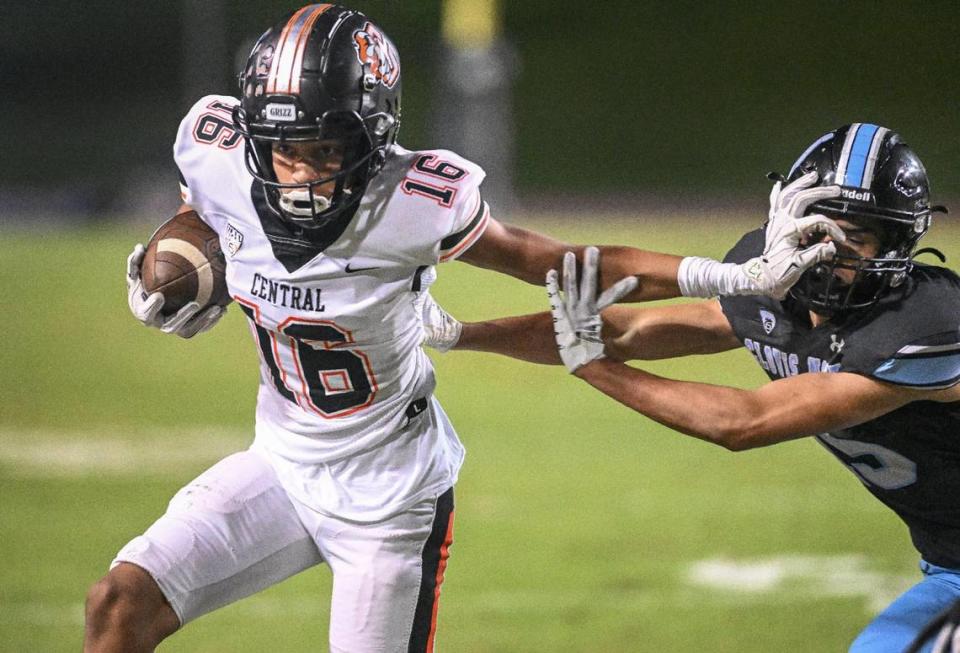 Central wide receiver Zeb White stiff-arms his way to a first down against Clovis North in their Tri-River Athletic Conference football final at Veterans Memorial Stadium on Thursday, Oct. 26, 2023.