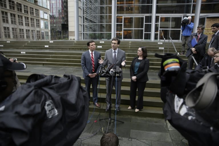 Washington State Attorney General Bob Ferguson (centre) talks to reporters in Seattle, after a hearing about President Trump's travel ban