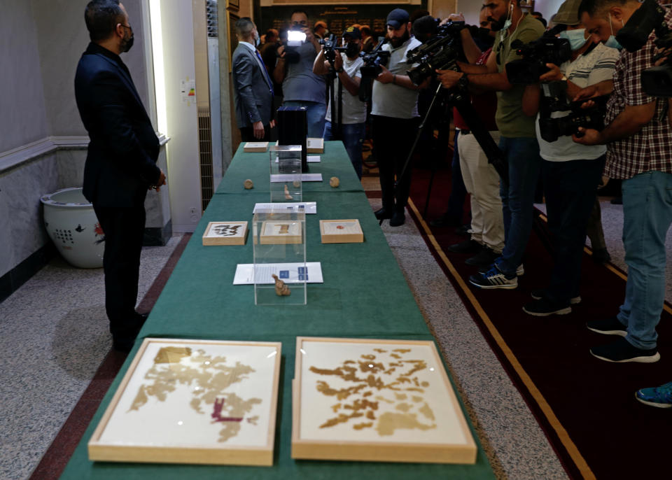 Recently recovered antiquities are displayed at the foreign ministry, in Baghdad, Iraq, Tuesday, Aug. 3, 2021. Over 17,000 looted ancient artefacts recovered from the United States and other countries were handed over to Iraq's Culture Ministry on Tuesday, a restitution described by the government as the largest in the country's history. The majority of the artefacts date back 4,000 years to ancient Mesopotamia and were recovered from the U.S. in a recent trip by Prime Minister Mustafa al-Kadhim. (AP Photo/Khalid Mohammed)