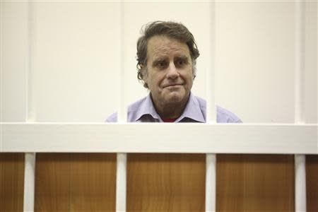 Peter Willcox, captain of the Greenpeace ship Arctic Sunrise, sits in the defendants' cage during a court hearing in St. Petersburg November 20, 2013. REUTERS/Maxim Zmeyev