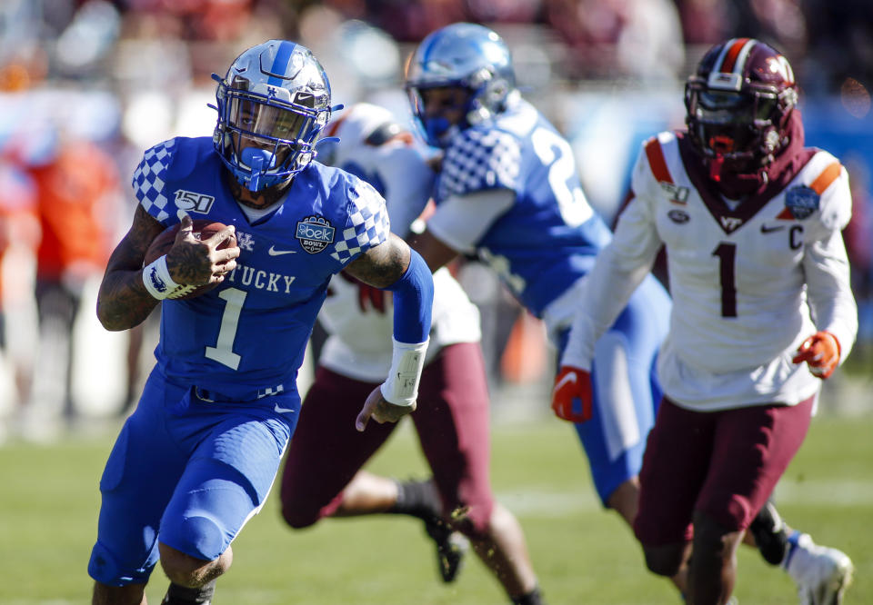 Kentucky quarterback Lynn Bowden Jr. (1) breaks free for a 25-yard touchdown run against Virginia Tech in the first half of the Belk Bowl NCAA college football game in Charlotte, N.C., Tuesday, Dec. 31, 2019. (AP Photo/Nell Redmond)