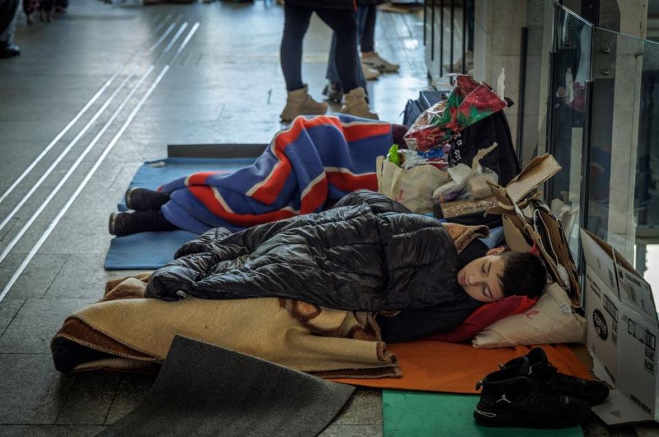 Ukraine children find rest on the second floor of a busy train station in Warsaw Poland on March 10, 2022.