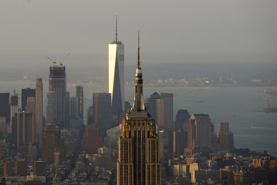 The rising sun illuminates the Empire State Building and One World Trade building in New York, U.S., November 2, 2016. REUTERS/Lucas Jackson